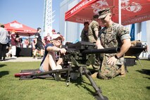 A U.S. Marine assigned to Special Purpose Marine Air-Ground Task Force-250, interacts with an attendee during Marine Week Atlanta, Aug. 31, 2025. Marines stationed across the globe commemorate the 250th anniversary of the Marine Corps, honoring a distinguished legacy of service, sacrifice, and unwavering fidelity to both the nation and fellow Marines. (U.S. Marine Corps photo by Lance Cpl. Kiara Rawls)