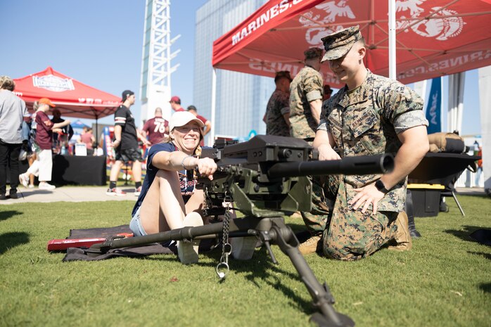 A U.S. Marine assigned to Special Purpose Marine Air-Ground Task Force-250, interacts with an attendee during Marine Week Atlanta, Aug. 31, 2025. Marines stationed across the globe commemorate the 250th anniversary of the Marine Corps, honoring a distinguished legacy of service, sacrifice, and unwavering fidelity to both the nation and fellow Marines. (U.S. Marine Corps photo by Lance Cpl. Kiara Rawls)