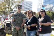 A U.S. Marine assigned to Special Purpose Marine Air-Ground Task Force-250, poses for a photo with attendees during Marine Week Atlanta, Aug. 30, 2025. Marines stationed across the globe commemorate the 250th anniversary of the Marine Corps, honoring a distinguished legacy of service, sacrifice, and unwavering fidelity to both the nation and fellow Marines. (U.S. Marine Corps photo by Lance Cpl. Kiara Rawls)