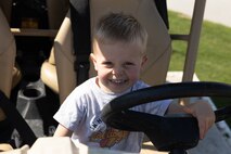 A child smiles for a photo at the static display of Marine Corps equipment during Marine Week Atlanta, Aug. 31, 2025. Marines stationed across the globe commemorate the 250th anniversary of the Marine Corps, honoring a distinguished legacy of service, sacrifice, and unwavering fidelity to both the nation and fellow Marines. (U.S. Marine Corps photo by Lance Cpl. Kiara Rawls)