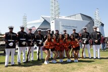 The U.S. Marine Corps Silent Drill Platoon, assigned to Marine Barracks Washington, pose for a photo with cheerleaders from Virginia Tech during Marine Week Atlanta, Aug. 31, 2025. Marines stationed across the globe commemorate the 250th anniversary of the Marine Corps, honoring a distinguished legacy of service, sacrifice, and unwavering fidelity to both the nation and the Corps. (U.S. Marine Corps photo by Lance Cpl. Kiara Rawls)