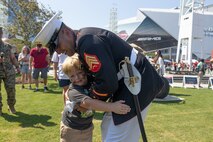 U.S. Marine Sgt. Alex Rojas, assigned to Marine Barracks Washington, hugs a child  during Marine Week Atlanta, Aug. 31, 2025. Marines stationed across the globe commemorate the 250th anniversary of the Marine Corps, honoring a distinguished legacy of service, sacrifice, and unwavering fidelity to both the nation and fellow Marines. (U.S. Marine Corps photo by Lance Cpl. Kiara Rawls)