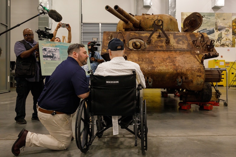 U.S. Marine Corps veteran Cpl. Leighton Willhite, who served in the Battle of Iwo Jima, right, talks about the tank he drove with Jonathan Bernstein, curator of arms and armor at the National Museum of the Marine Corps, left, at the Museum Support Facility in Dumfries, Virginia.