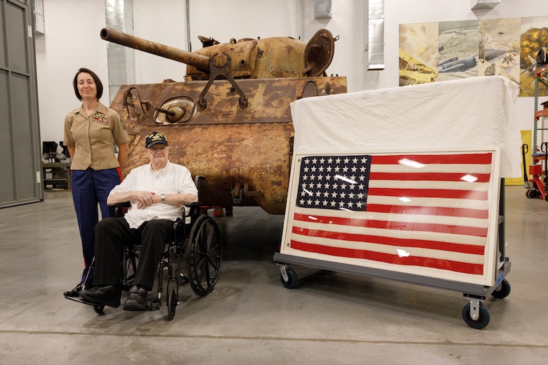 U.S. Marine Corps veteran Cpl. Leighton Willhite, who served in the Battle of Iwo Jima, right, poses for a photo in front of the WWII Sherman tank with Master gunnery Gt. Lisa Marshall, Senior Career Counselor, at the Museum Support Facility in Dumfries, Virginia.