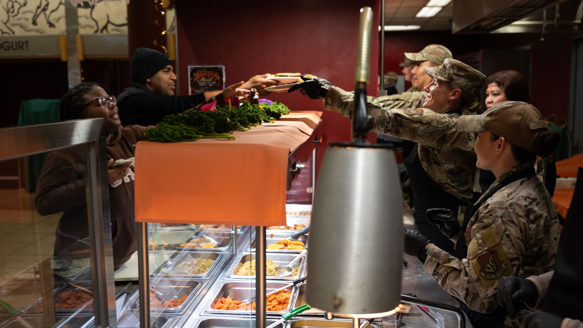 U.S. Air Force leaders serve food to Airmen at Osan Air Base, Republic of Korea, Nov. 27, 2025. The Gingko Dining Facility served a traditional Thanksgiving meal with 51st FW senior leaders and volunteers continuing the long military tradition of serving Airmen during the holidays. (U.S. Air Force photo by Senior Airman Rome Bowermaster)