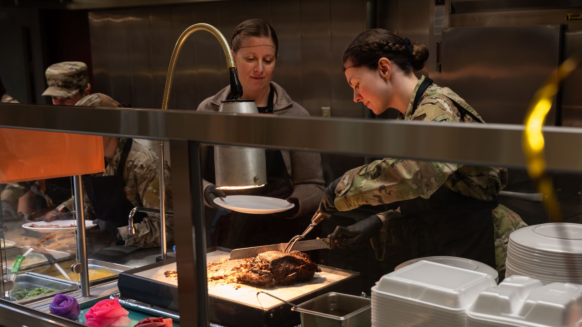 U.S. Air Force leadership serve food during a Thanksgiving event at the Gingko Dining Facility at Osan Air Base, Republic of Korea, Nov. 27, 2025. The tradition of leaders serving Airmen reflects core values and fosters connection during the holiday season. (U.S. Air Force photo by Senior Airman Rome Bowermaster)
