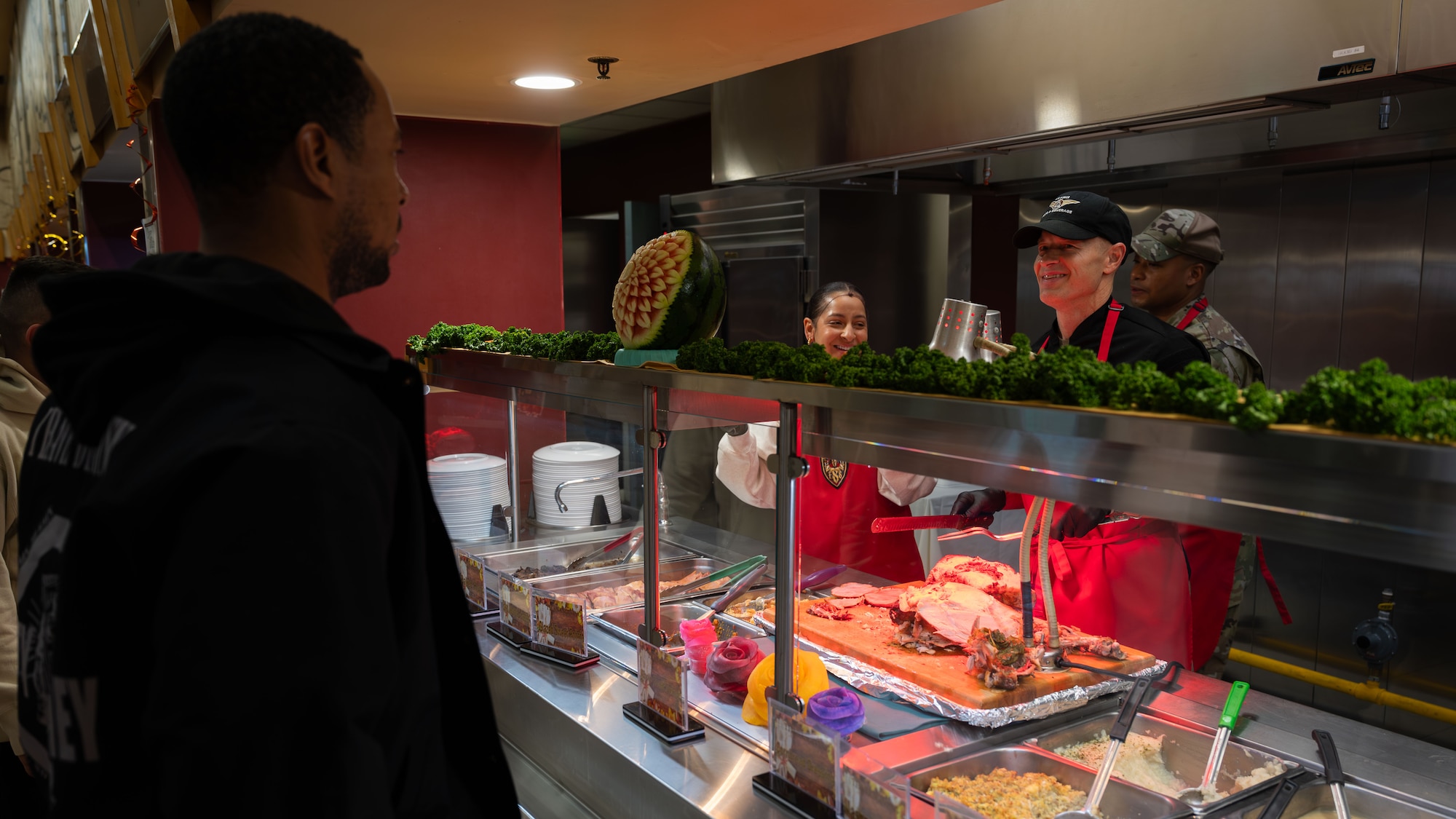 U.S. Air Force Col. Ryan Ley, right, 51st Fighter Wing commander, serves an Airman during a Thanksgiving meal at Osan Air Base, Republic of Korea, Nov. 27, 2025. Sharing the holiday with Airmen highlighted a leadership priority of fostering trust and teamwork during high-tempo operations. (U.S. Air Force photo by Senior Airman Rome Bowermaster)