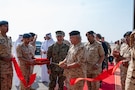 MANAMA, Bahrain (Dec. 1, 2025) His Royal Highness Prince Salman bin Hamad Al-Khalifa, Crown Prince, Deputy Supreme Commander and Prime Minister of Bahrain, cuts a ribbon with U.S. Navy Adm. Brad Cooper, commander of U.S. Central Command, commemorating the opening of the Combined Command Post at Ras Al Bar Camp. The event marked the opening of a new Combined Command Post for air defense staffed by Bahrain and U.S. forces.  (U.S. Navy photo by Mass Communication Specialist 2nd Class Lindsay Lair)