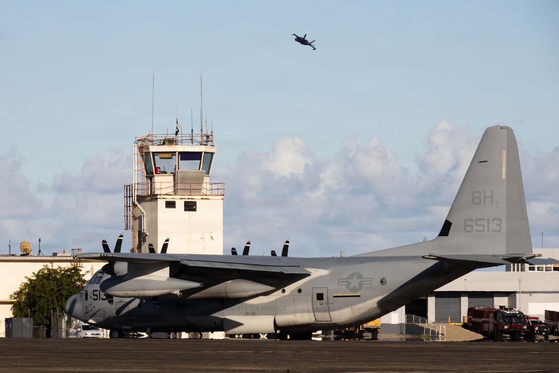 A U.S. Marine Corps KC-130J Super Hercules assigned to Marine Aerial Refueler Transport Squadron (VMGR) 252, Marine Aircraft Group 14, 2nd Marine Aircraft Wing, is parked on the flightline while a U.S. Marine Corps F-35B Lightning II assigned to Marine Fighter Attack Squadron (VMFA) 225, U.S. Marine Corps Forces, South, takes off at Jose Aponte de la Torre Airport in Ceiba, Puerto Rico, Nov. 20, 2025. U.S. military forces are deployed to the Caribbean in support of the U.S. Southern Command mission, Department of War-directed operations, and the president’s priorities to disrupt illicit drug trafficking and protect the homeland. (U.S. Marine Corps photo)