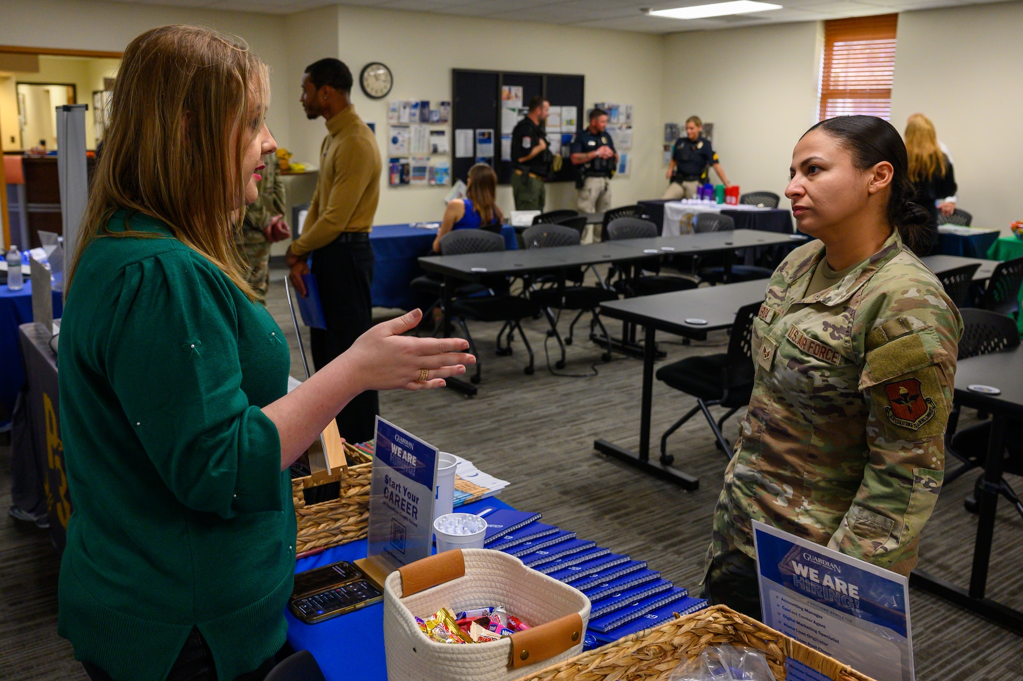 Senior Airman Evan Porter, 42d Air Base Wing Public Affairs journeyman, speaks with representatives from Alabama Ag Credit at the Military and Family Readiness Center career fair at Maxwell Air Force Base, Alabama, Nov. 25, 2025. The quarterly M&FRC career fairs help Airmen separating from the U.S. Air Force find employment at local companies and government agencies. (U.S. Air Force photo by Senior Airman Evan Lichtenhan)