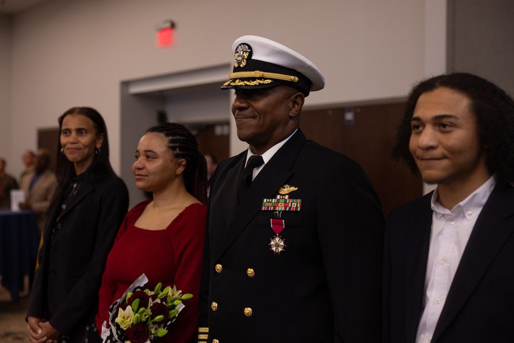 U.S. Navy Capt. Arthur Wiggins, center, from Virginia, former wing chaplain, 2nd Marine Aircraft Wing, poses for a photo with family members during his retirement ceremony at Marine Corps Air Station Cherry Point, North Carolina, Nov. 21, 2025. In April of 2004, Wiggins commissioned as a Lieutenant in the Navy Chaplain Corps after previously serving 14 years in the Marine Corps.  In 2025, Wiggins completed his military career as the wing chaplain for 2nd MAW. (U.S. Marine Corps photo by Lance Cpl. Orlanys Diaz Figueroa)