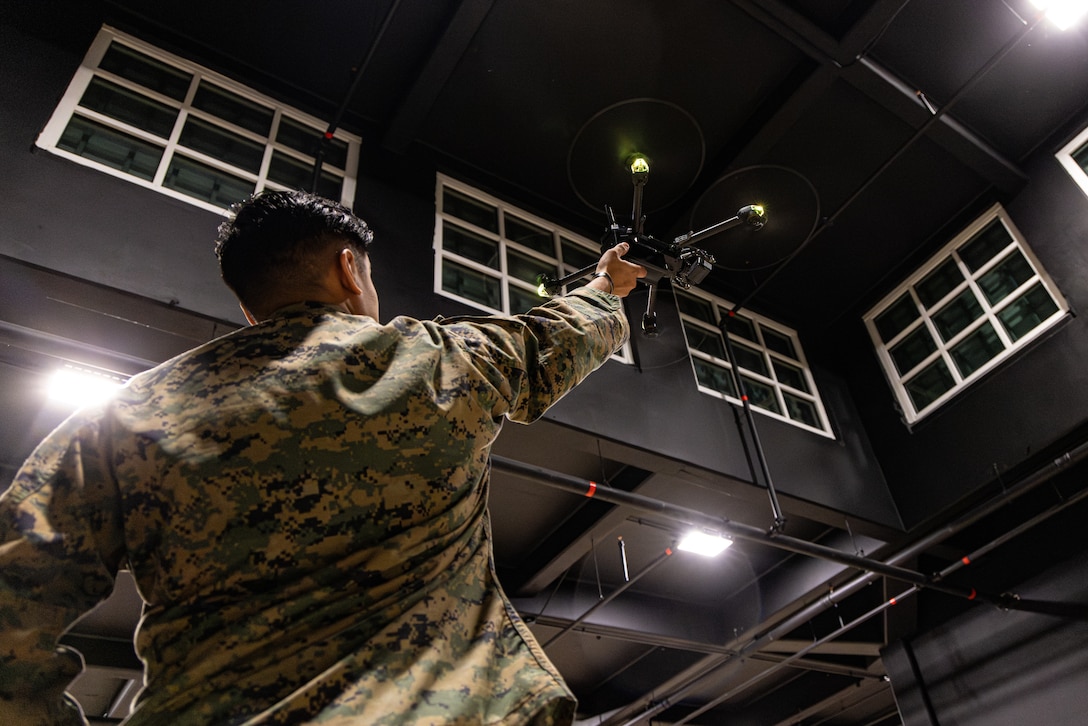 U.S. Marine Corps Lance Cpl. Giancarlos Maldonado, a native of Pennsylvania, and a drone operator with Headquarters Company, 6th Marine Regiment, 2nd Marine Division, hand launches a Skydio X2D to demonstrate Small Unmanned Aircraft System capabilities on Marine Corps Base Camp Lejeune, North Carolina, Nov. 21, 2025. Drone operators showcased Small Unmanned Aircraft Systems capabilities to 6th Regiment leadership and staff to provide an understanding for first person view operations and tactics. (U.S. Marine Corps photo by Lance Cpl. Judith Ann Lazaro)