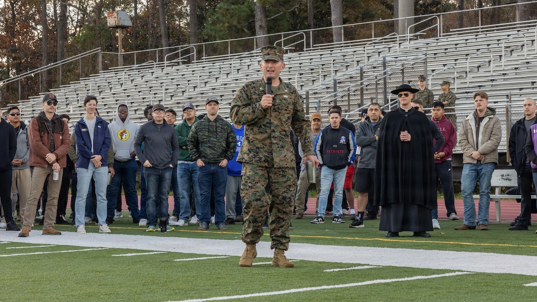 U.S. Navy Lt. David Miloscia, the chaplain for Headquarters and Service Battalion, 2nd Marine Logistics Group, gives an invocation during the 2025 H&S Bn Turkey Bowl at Marine Corps Base Camp Lejeune, North Carolina, Nov. 25, 2025. The Turkey Bowl consisted of a flag football tournament and chili cooking competition to raise camaraderie and esprit de corps throughout the battalion. (U.S. Marine Corps photo by Lance Cpl. Talan Werner)