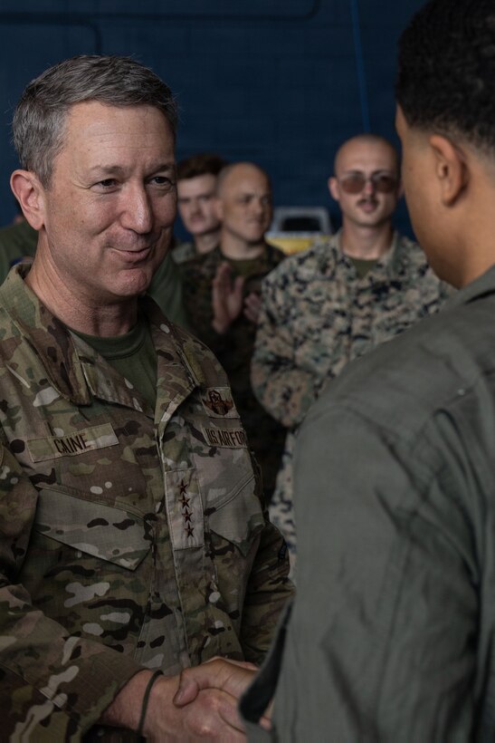 Chairman of the Joint Chiefs of Staff Gen. Dan Caine recognizes a U.S. Marine with Marine Fighter Attack Squadron (VMFA) 225, U.S. Marine Corps Forces, South, for outstanding performance at Jose Aponte de la Torre Airport in Ceiba, Puerto Rico, Nov. 24, 2025. U.S. military forces are deployed to the Caribbean in support of the U.S. Southern Command mission, Department of War-directed operations, and the president’s priorities to disrupt illicit drug trafficking and protect the homeland. (U.S. Marine Corps photo)