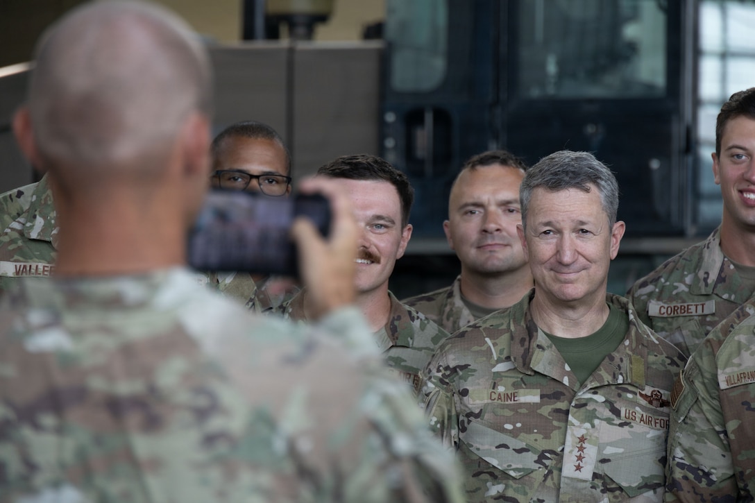 Chairman of the Joint Chiefs of Staff Gen. Dan Caine poses for a photo with U.S. Airmen with the 346th Air Expeditionary Wing at Jose Aponte de la Torre Airport in Ceiba, Puerto Rico, Nov. 24, 2025. U.S. military forces are deployed to the Caribbean in support of the U.S. Southern Command mission, Department of War-directed operations, and the president’s priorities to disrupt illicit drug trafficking and protect the homeland. (U.S. Marine Corps photo)