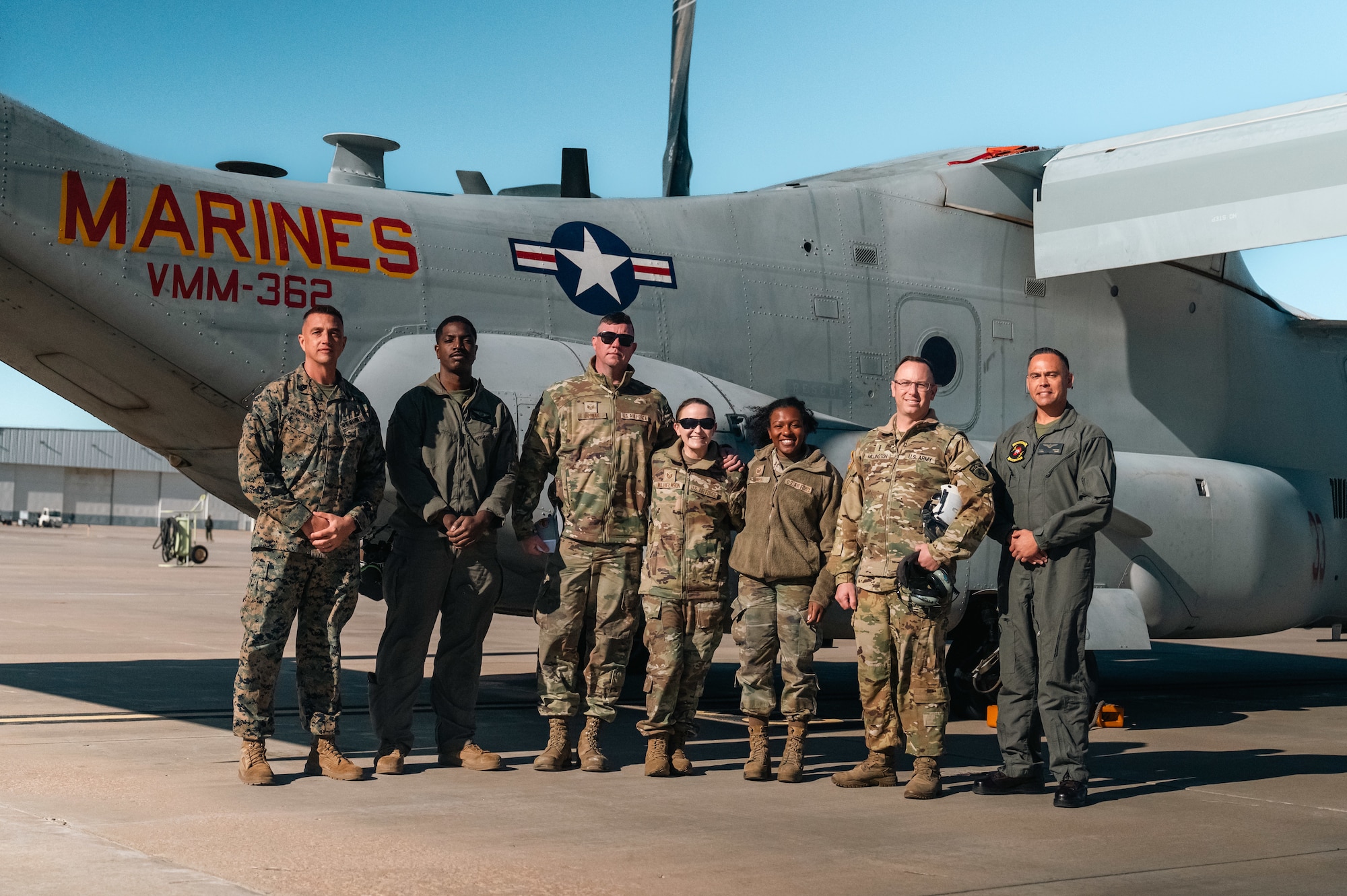 service members pose for group photos