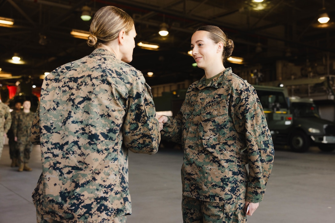 U.S. Marine Corps Col. Jenny Colegate, base commander of Marine Corps Base Quantico, left, congratulates Sgt. Kayli Merritt, an expeditionary firefighting and rescue specialist with Marine Corps Air Facility, during Merritt’s meritorious promotion to sergeant at MCAF, on MCB Quantico, Virginia, Nov. 24, 2025. A meritorious promotion is based on the individual Marines ability to take on the responsibilities and duties of a higher grade in an effective manner. (U.S. Marine Corps photo by Lance Cpl. Harleigh Faulk)