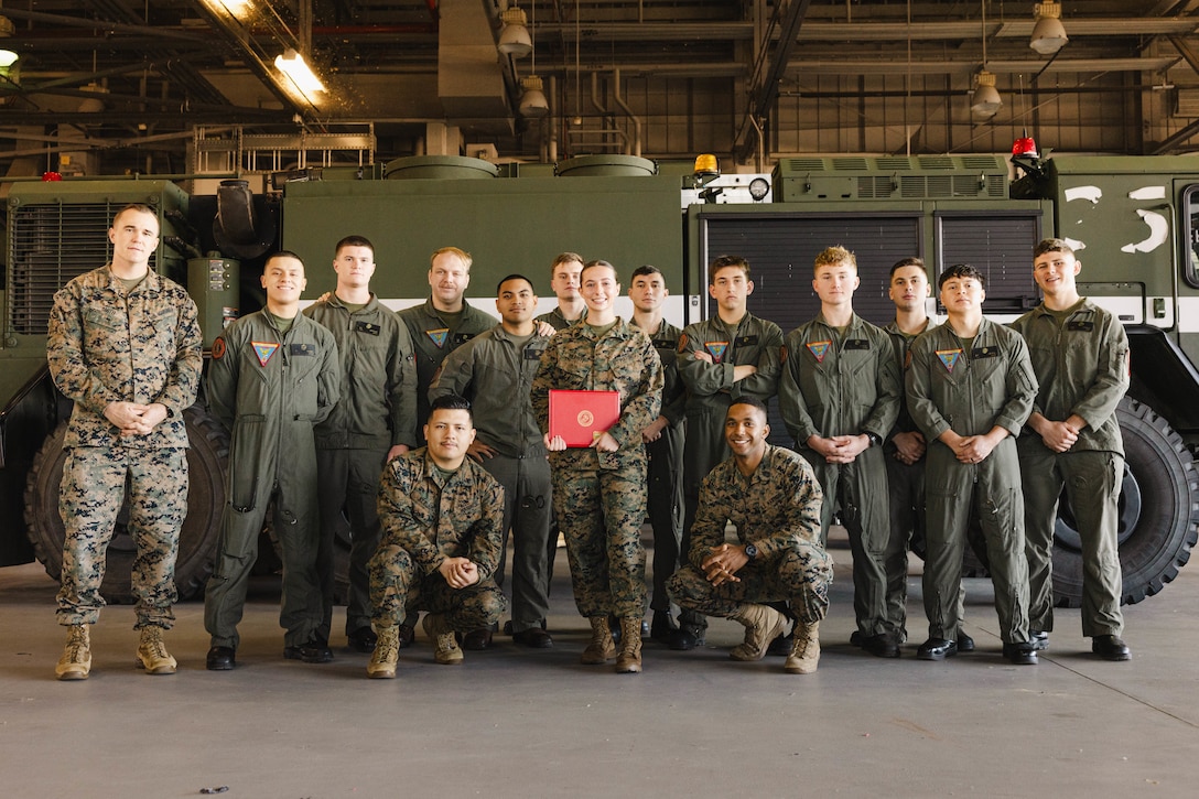U.S. Marine Corps Sgt. Kayli Merritt, an expeditionary firefighting and rescue specialist with Marine Corps Air Facility, poses for a photo with her unit after her meritorious promotion to sergeant at MCAF, on MCB Quantico, Virginia, Nov. 24, 2025. A meritorious promotion is based on the individual Marines ability to take on the responsibilities and duties of a higher grade in an effective manner. (U.S. Marine Corps photo by Lance Cpl. Harleigh Faulk)