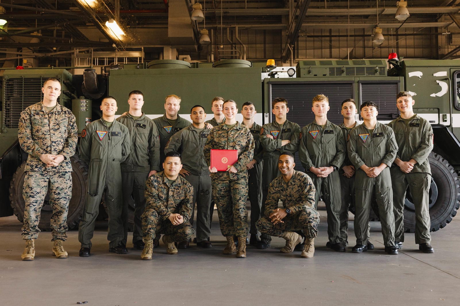 U.S. Marine Corps Sgt. Kayli Merritt, an expeditionary firefighting and rescue specialist with Marine Corps Air Facility, poses for a photo with her unit after her meritorious promotion to sergeant at MCAF, on MCB Quantico, Virginia, Nov. 24, 2025. A meritorious promotion is based on the individual Marines ability to take on the responsibilities and duties of a higher grade in an effective manner. (U.S. Marine Corps photo by Lance Cpl. Harleigh Faulk)