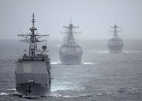 The Ticonderoga-class guided missile cruiser USS Cape St. George (CG 71) leads the Arleigh Burke-class guided missile destroyers USS Momsen (DDG 92) and USS Sterett (DDG 104) trail the Nimitz-class aircraft carrier USS Abraham Lincoln (CVN 72) during a training exercise. Cape St. George is equipped with four AN/SPG-62 Fire Control Radars, which are mounted high on the vessel to ensure a clear line of sight. These radars are arranged to provide nearly 360-degree engagement capability for the Aegis Combat System. (U.S. Navy photo by Petty Officer 2nd Class Colby Neal)