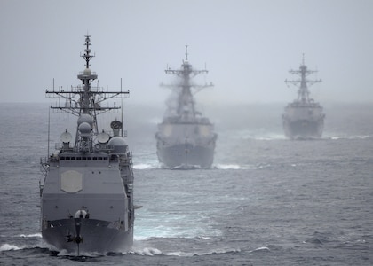 The Ticonderoga-class guided missile cruiser USS Cape St. George (CG 71) leads the Arleigh Burke-class guided missile destroyers USS Momsen (DDG 92) and USS Sterett (DDG 104) trail the Nimitz-class aircraft carrier USS Abraham Lincoln (CVN 72) during a training exercise. Cape St. George is equipped with four AN/SPG-62 Fire Control Radars, which are mounted high on the vessel to ensure a clear line of sight. These radars are arranged to provide nearly 360-degree engagement capability for the Aegis Combat System. (U.S. Navy photo by Petty Officer 2nd Class Colby Neal)
