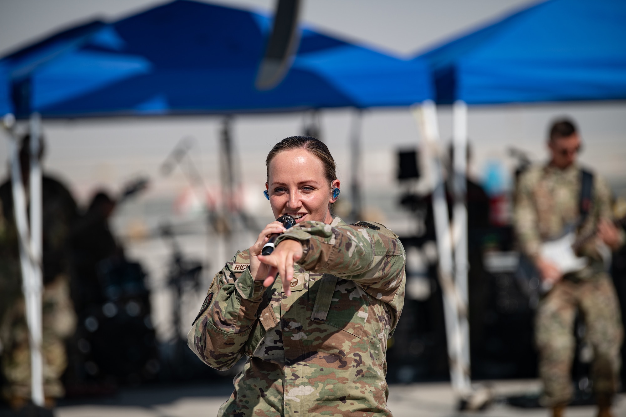 Person in uniform sings into microphone