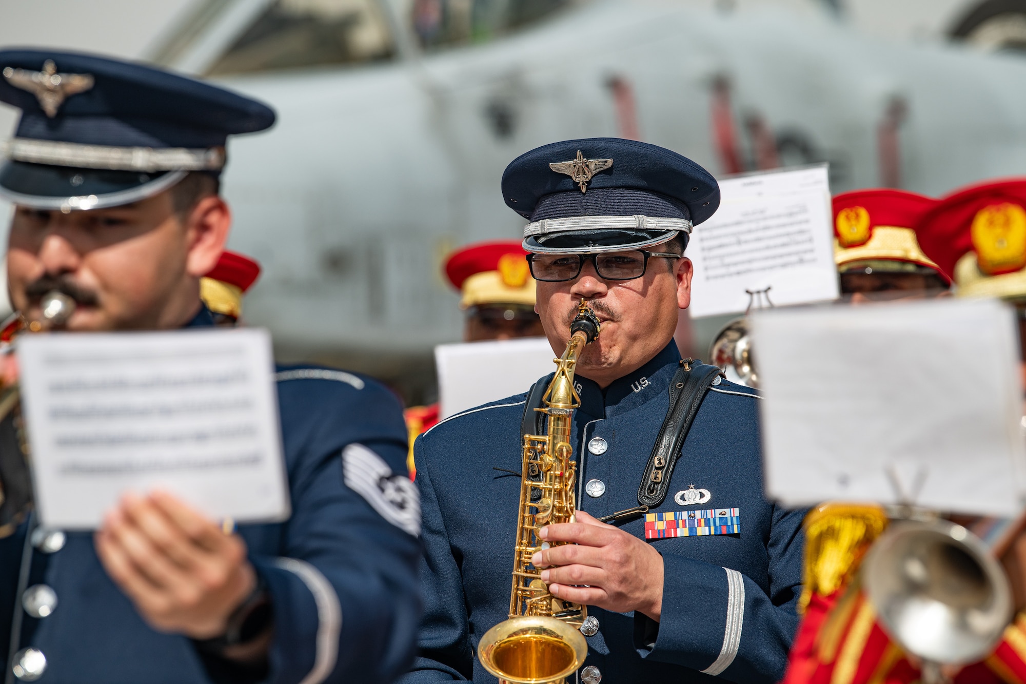 People in military uniforms play musical instruments