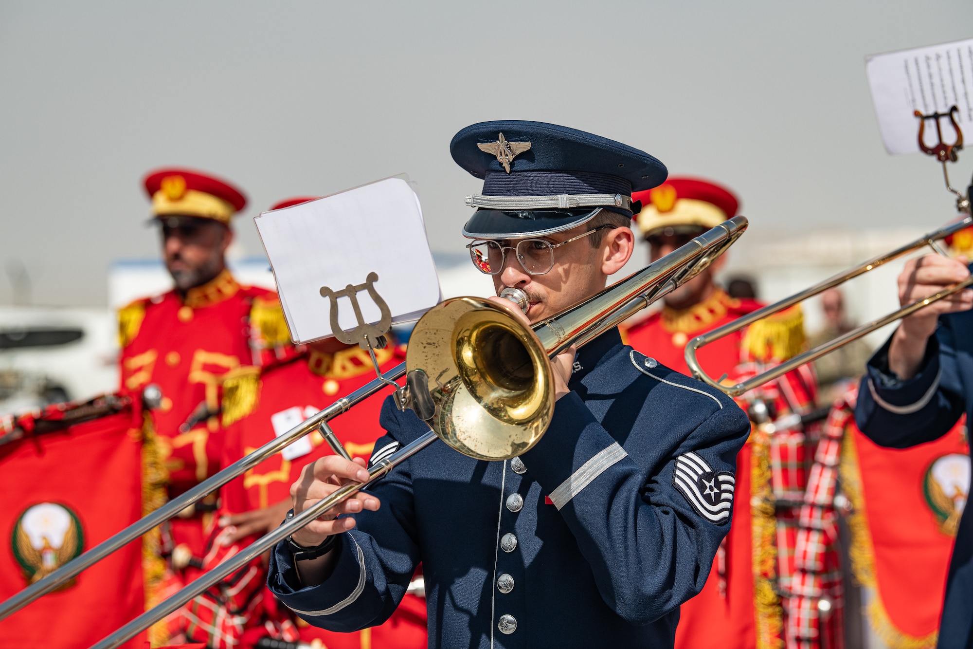 People in military uniform play musical instruments