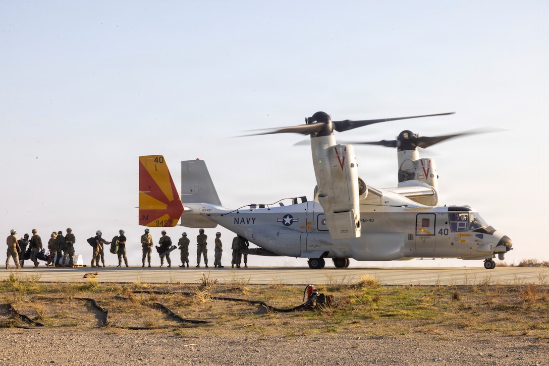 U.S. Marines and Sailors offload supplies from a CMV-22B Osprey assigned to Fleet Logistics Multi-Mission Squadron (VRM) 40 at Red Beach Combat Town, Marine Corps Base Camp Pendleton, California, Oct. 27, 2025.