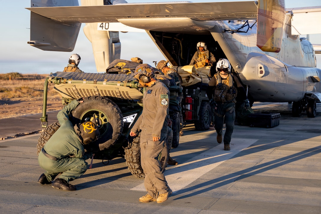 U.S. Marines and Sailors load a Tactical Air-Ground Refueling System onto a Navy CMV-22B Osprey assigned to Fleet Logistics Multi-Mission Squadron (VRM) 40, Fleet Logistics Multi-Mission Wing Atlantic, during the Naval Aviation Warfighting Development Center’s joint training at Marine Corps Base Camp Pendleton, California, Oct. 29, 2025.
