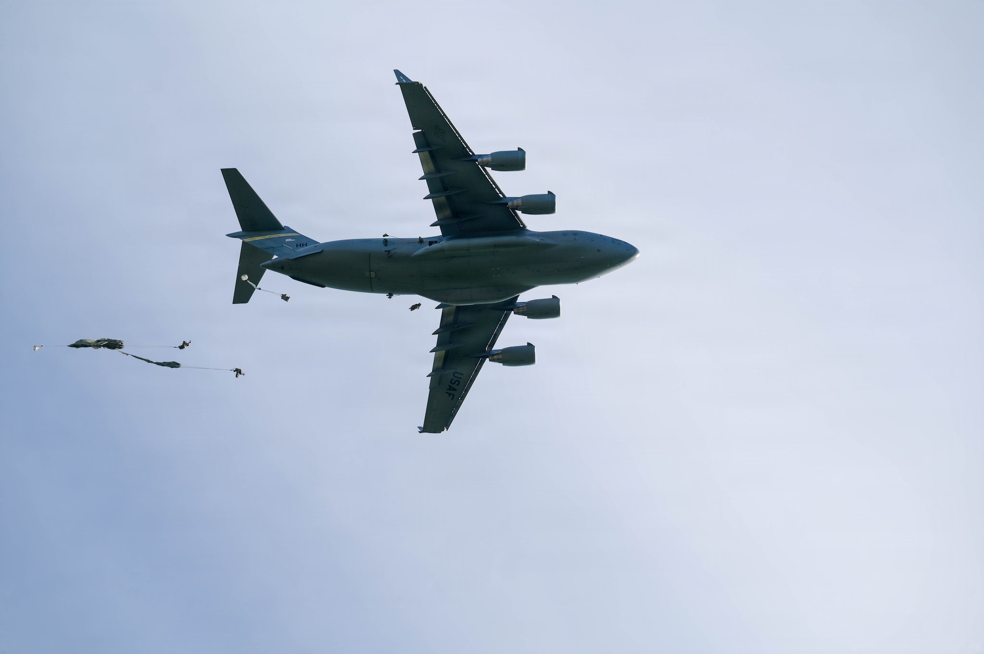 A U.S. Air Force aircraft delivers parachuted soldiers.