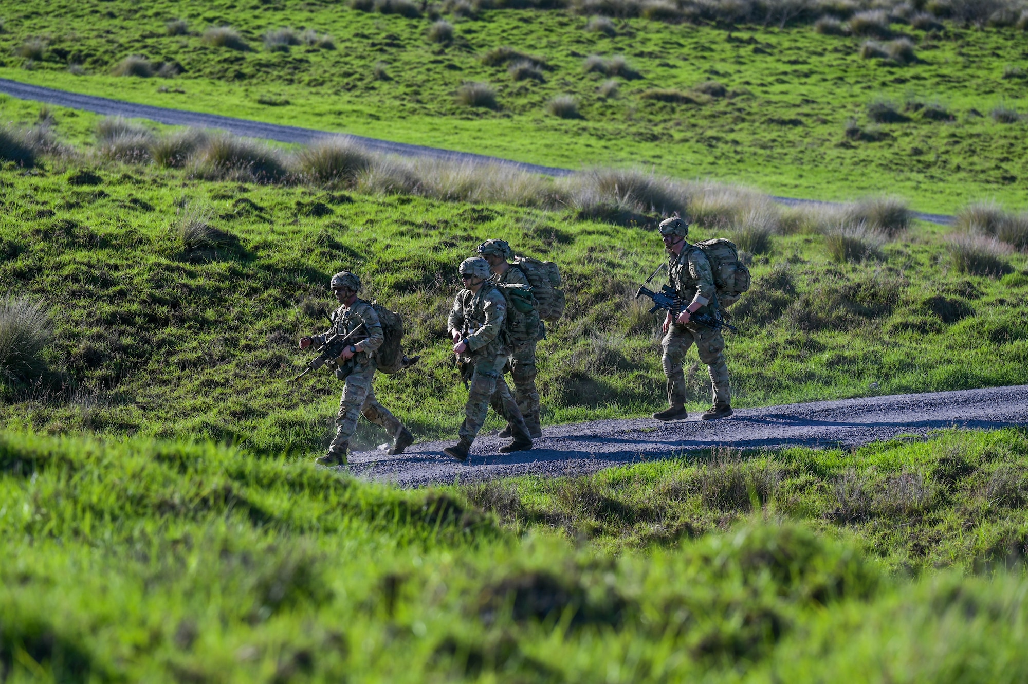 U.S. Army soldiers walking on a trail.