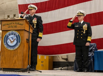 Adm. Karl Thomas, commander, U.S. Fleet Forces Command (USFFC), and Adm. Daryl Caudle, Chief of Naval Operations, salute during the USFFC assumption of command ceremony in the hangar bay aboard the Nimitz-class aircraft carrier USS Harry S. Truman (CVN 75). USFFC is responsible for manning, training, equipping and providing combat-ready forces forward to numbered fleets and combatant commanders around the globe. (U.S. Navy photo by Mass Communication Specialist 2nd Class Dustin Knight/Released)