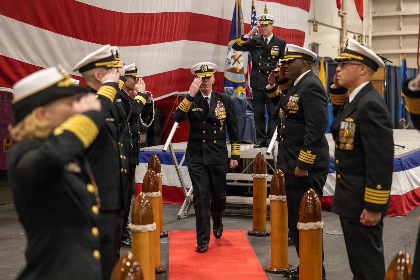 Adm. Karl Thomas, commander, U.S. Fleet Forces Command (USFFC), salutes side boys during the USFFC assumption of command ceremony in the hangar bay aboard the Nimitz-class aircraft carrier USS Harry S. Truman (CVN 75). USFFC is responsible for manning, training, equipping and providing combat-ready forces forward to numbered fleets and combatant commanders around the globe. (U.S. Navy photo by Mass Communication Specialist 2nd Class Dustin Knight/Released)