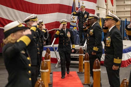 Adm. Karl Thomas, commander, U.S. Fleet Forces Command (USFFC), salutes side boys during the USFFC assumption of command ceremony in the hangar bay aboard the Nimitz-class aircraft carrier USS Harry S. Truman (CVN 75). USFFC is responsible for manning, training, equipping and providing combat-ready forces forward to numbered fleets and combatant commanders around the globe. (U.S. Navy photo by Mass Communication Specialist 2nd Class Dustin Knight/Released)