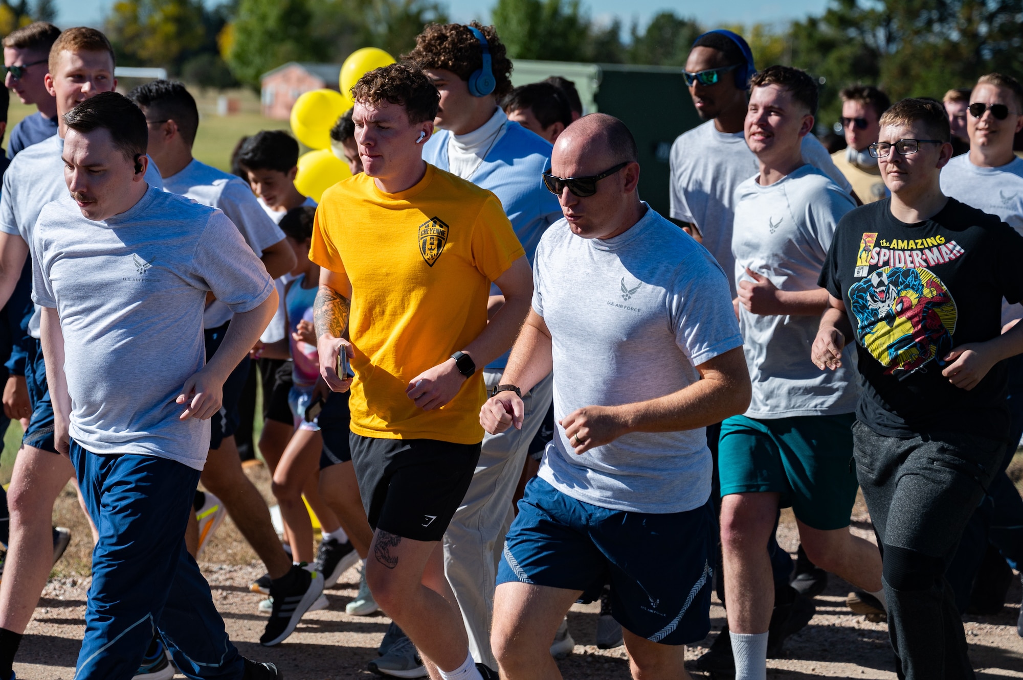 The 90th Missile Maintenance Squadron, along with 90 FSS, hosted a 5K to show support for Senior Airman Terrell Johnson’s daughter who recently beat cancer, participants were encouraged to wear yellow or dress as their favorite superhero. (U.S. Air Force photo by Airman Nicholas Rowe)