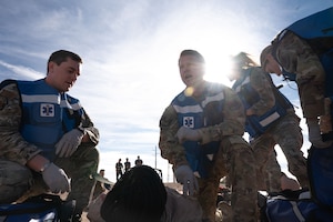 U.S. Air Force Airmen with the 355th Medical Group assess the wounds of a simulated casualty during an exercise scenario as part of Mosaic Lightning 26-1 at Davis-Monthan Air Force Base, Arizona, Nov. 13, 2025. A Wing Inspection Team oversaw the exercise, grading Airmen on their operational readiness. (U.S. Air Force photo by Airman 1st Class Jaden Kidd)