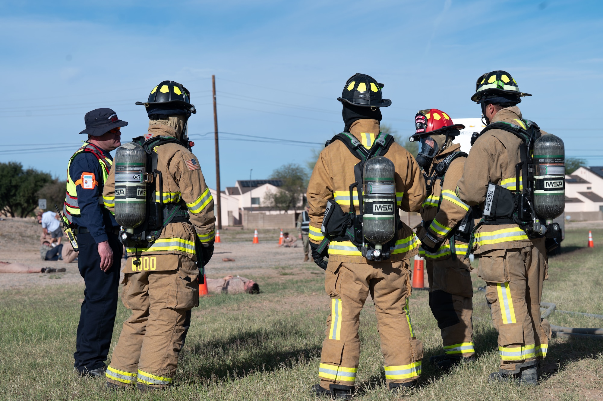 U.S. Air Force Airmen with the 355th Civil Engineer Squadron Fire Department strategize before participating in an exercise scenario during Mosaic Lightning 26-1 at Davis-Monthan Air Force Base, Arizona, Nov. 13, 2025. The firefighters responded to a scenario in which a trailer caught fire with dangerous chemicals inside. (U.S. Air Force photo by Airman 1st Class Jaden Kidd)