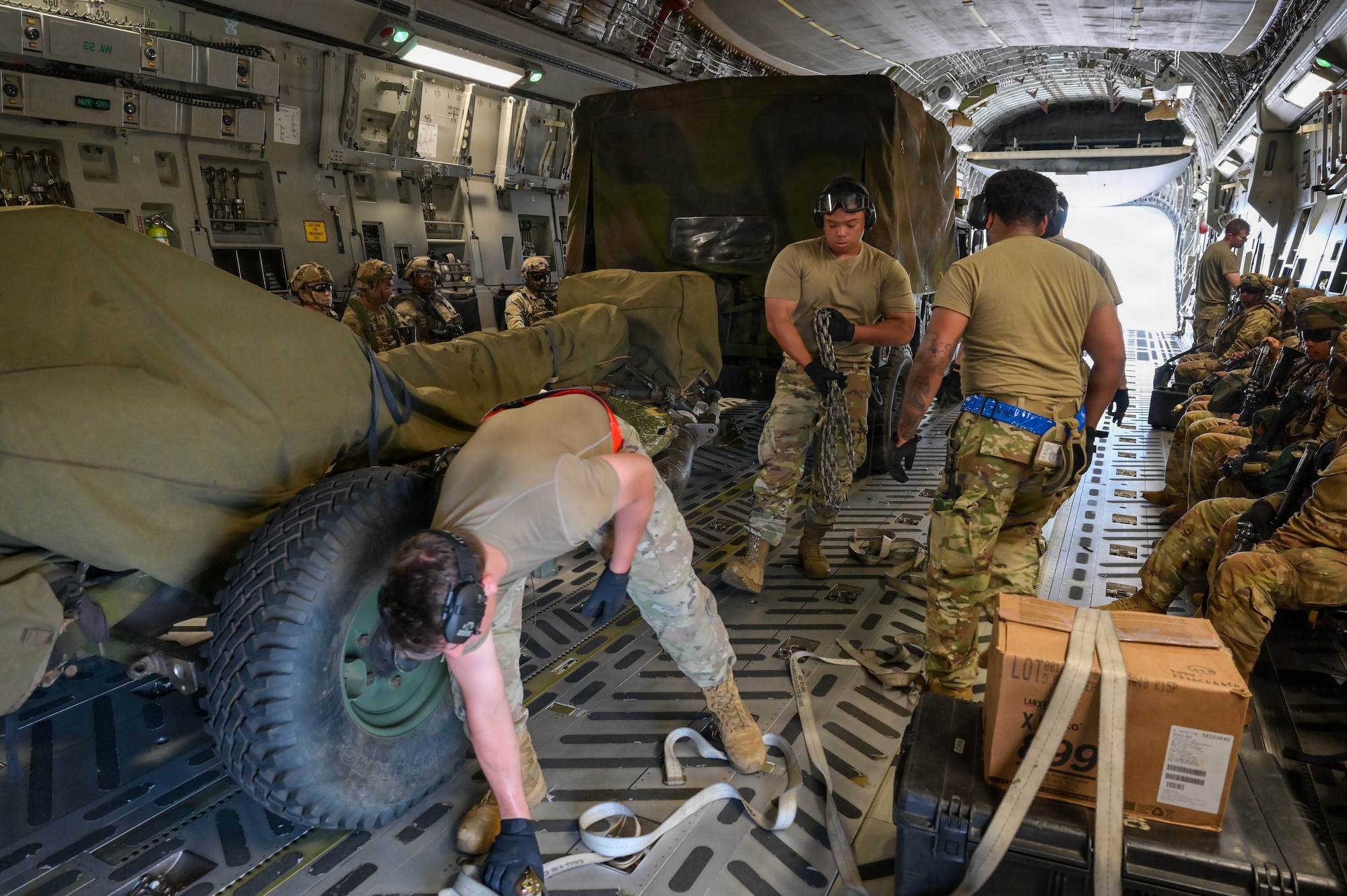 U.S. Air Force Airmen unloading U.S. Army equipment from a U.S. Air Force aircraft.