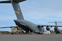 U.S. Army vehicles unloaded from a U.S. Air Force aircraft.
