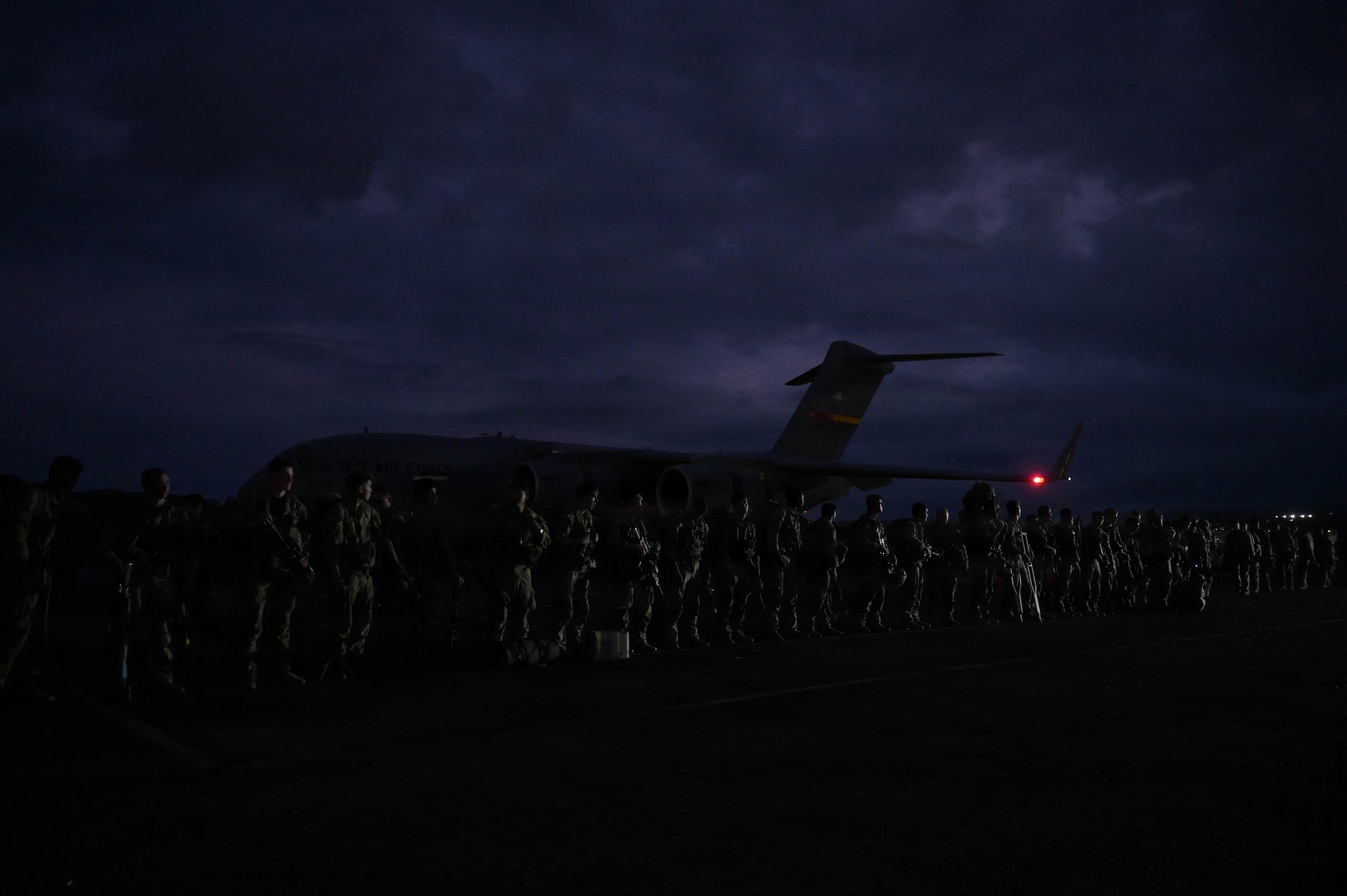 Soldiers in formation on a flightline.