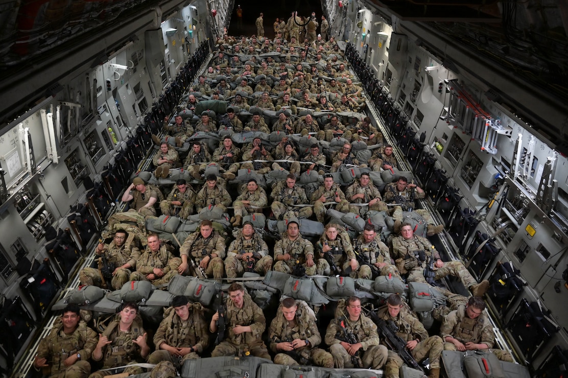 Nearly 200 soldiers inside of a U.S. Air Force aircraft at night.
