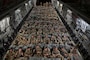 Nearly 200 soldiers inside of a U.S. Air Force aircraft at night.