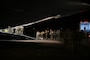 Soldiers entering a U.S. Air Force aircraft at night.