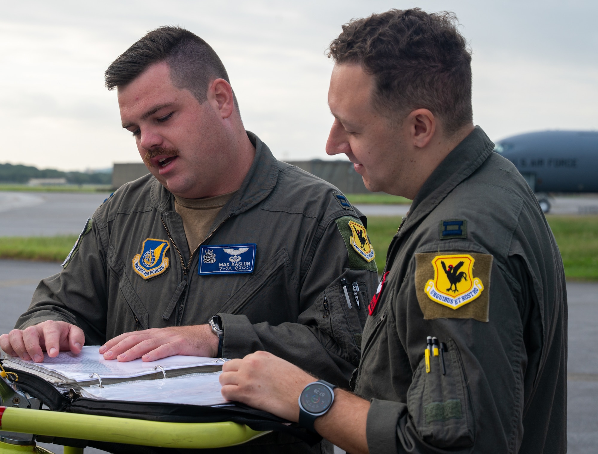 Two pilots go over preflight notes.