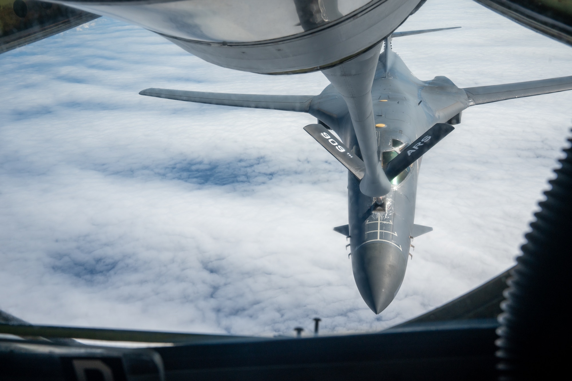 A U.S. Air Force B1-B Lancer is refueled in air by a KC-135 Stratotanker.