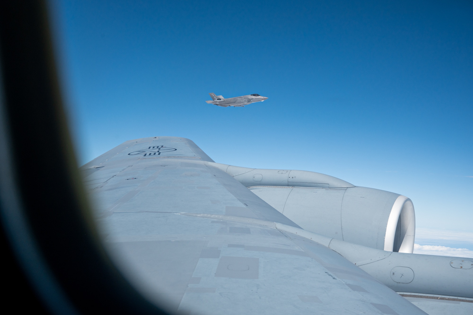 A U.S. Air Force F-35 Lightning II flies alongside a KC-135 Stratotanker