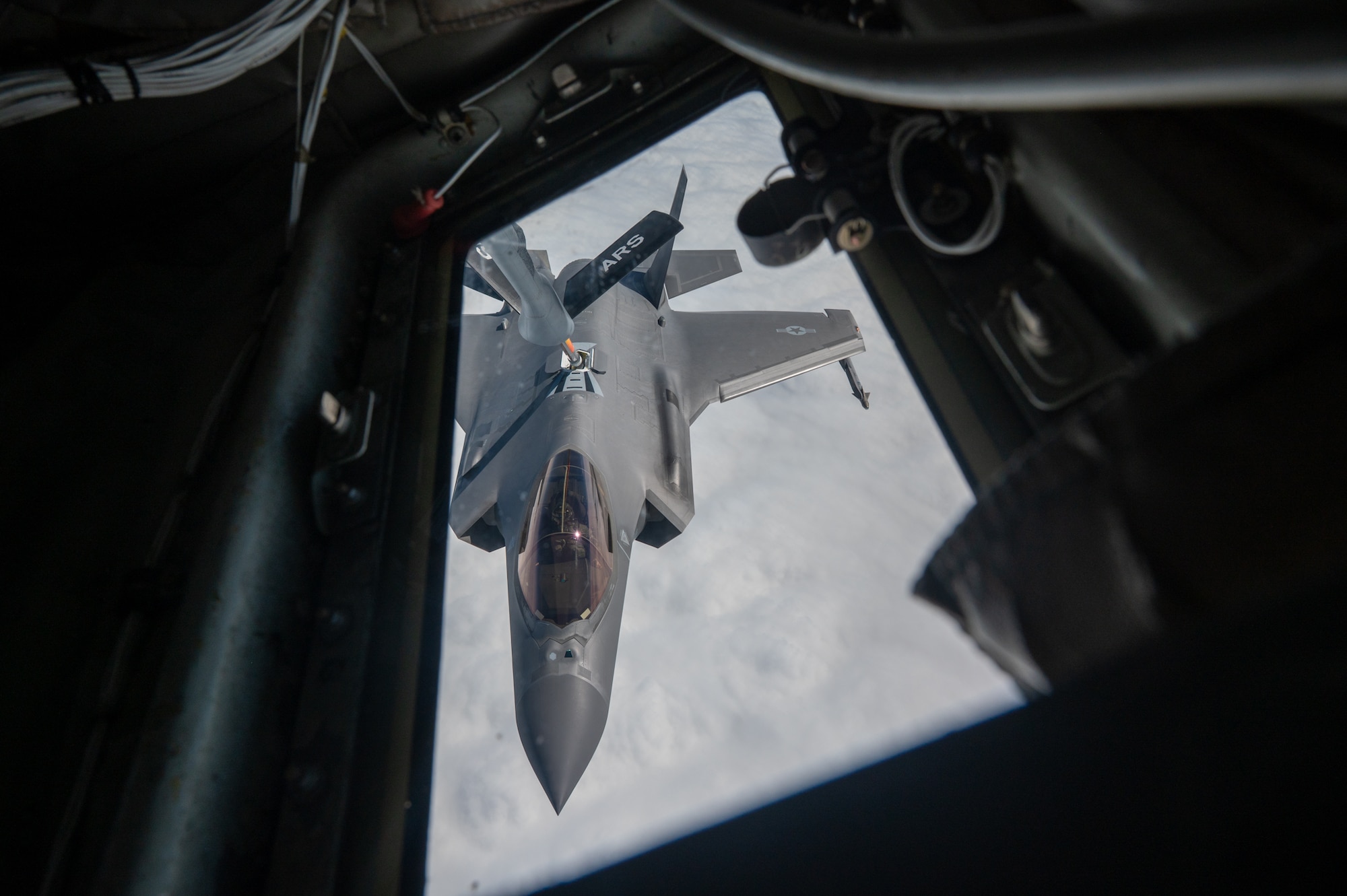 A U.S. Air Force F-35 Lightning II conducts in air refueling operations with a KC-135 Stratotanker.