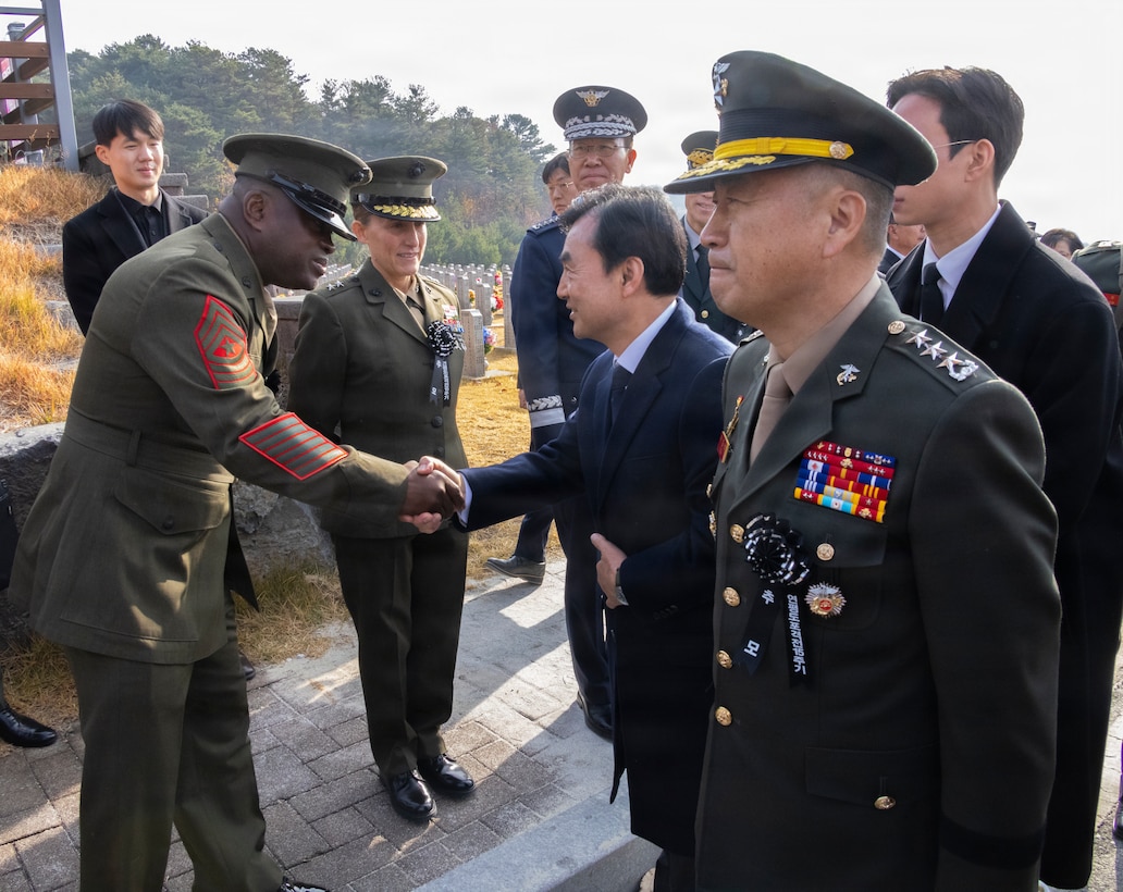 U.S. Marine Corps Sgt. Maj. Ismael G. Bamba, the command senior enlisted leader for U.S. Marine Corps Forces, Korea, shakes hands with Ahn Gyu-Back, the Republic of Korea Minister of National Defense, during a memorial ceremony for the 15th anniversary of the Bombardment of Yeonpyeong to honor the fallen ROK Marines and their unwavering actions in defense of their country, on Nov. 23, 2025. On Nov. 23, 2010, upon receiving North Korean artillery fire on Yeonpyeong Island, ROK Marine Corps forces responded swiftly and decisively with artillery counterfire to successfully defend the island in what is known today as the Bombardment of Yeonpyeong. (U.S. Marine Corps photos by Cpl. Simon Saravia)