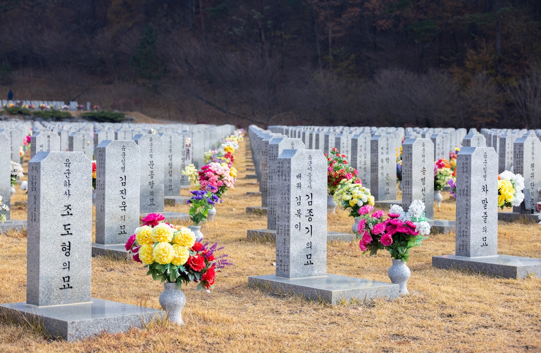 Headstones of fallen Republic of Korea service members rest during a memorial ceremony for the 15th anniversary of the Bombardment of Yeonpyeong at Daejeon National Cemetery in Daejeon, South Korea, on Nov. 23, 2025. On Nov. 23, 2010, upon receiving North Korean artillery fire on Yeonpyeong Island, ROK Marine Corps forces responded swiftly and decisively with artillery counterfire to successfully defend the island in what is known today as the Bombardment of Yeonpyeong. (U.S. Marine Corps photos by Cpl. Simon Saravia)